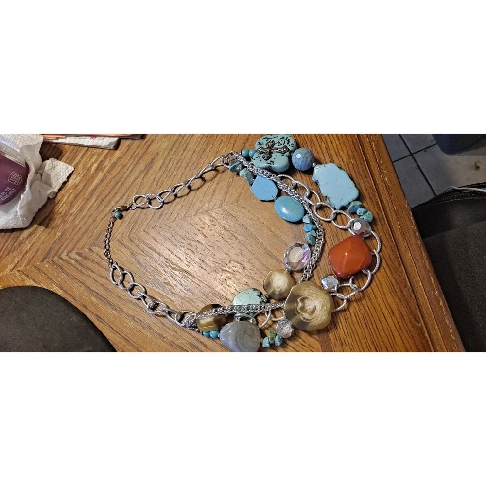 Southwestern-style statement piece featuring multiple strands of silver-toned...